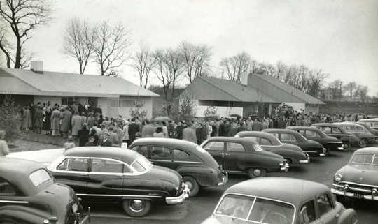 Buyers line up to purchase homes in Levittown, NY, the archetypal postwar suburb, built between 1947 and 1951. Until 1948, contracts for Levittown houses stated that the homes could not be owned or used by non-Caucasians. Mark Mathosian/Flickr, CC BY-NC-SA