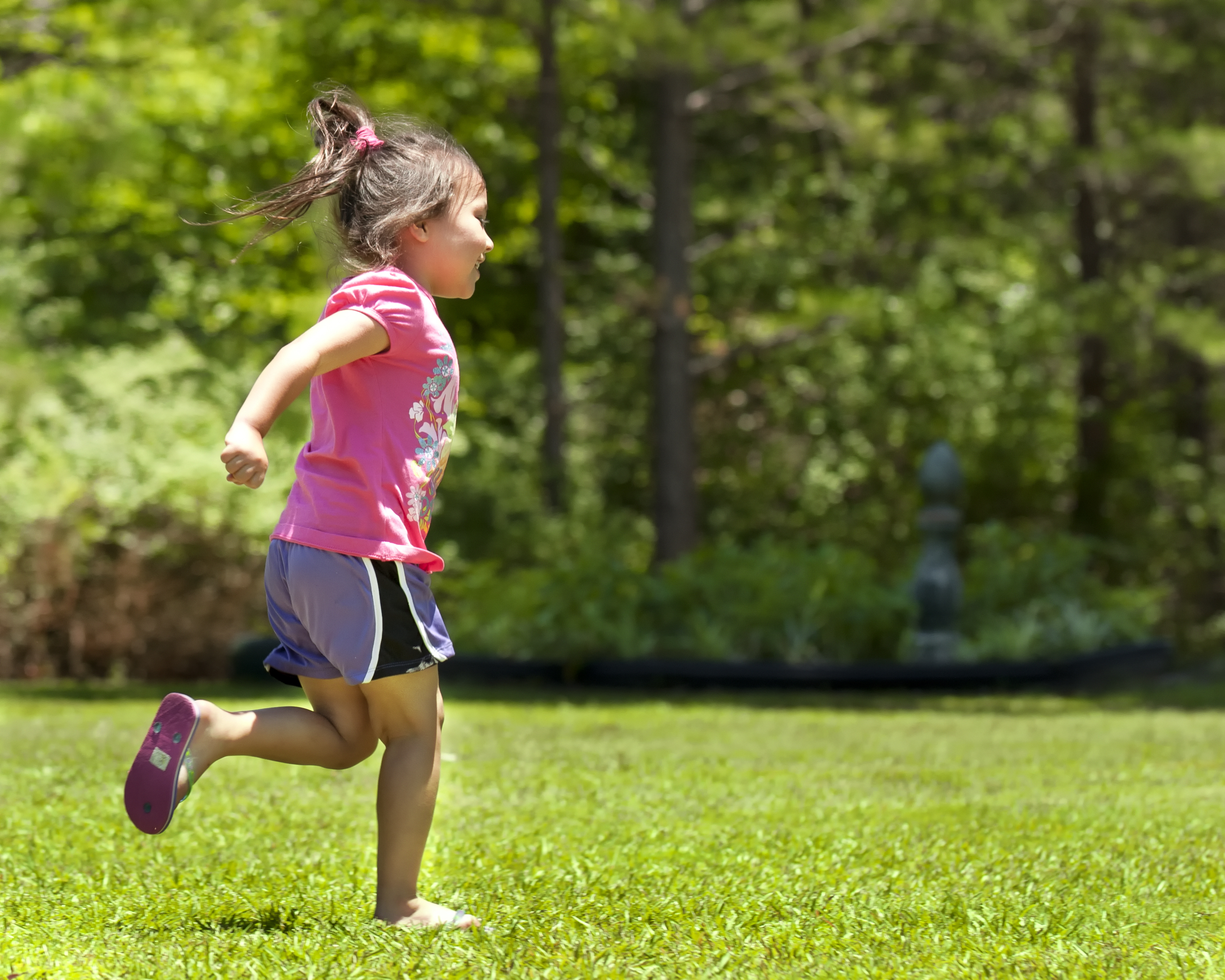A young girl running in the park.