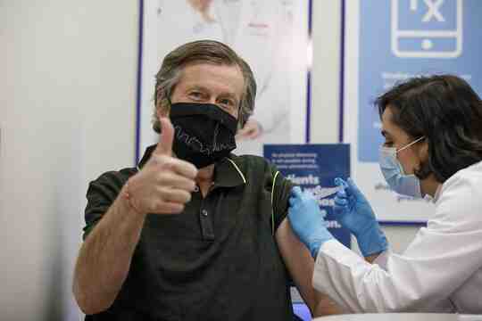 John Tory getting an injection, giving a thumbs-up