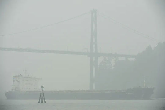 A ship passes under the Lion’s Gate Bridge in Vancouver, B.C., on Sept. 14, 2020. (10 tips for coping with wildfire smoke)