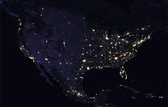 Satellite image of U.S. at night with cities brightly lit. 
