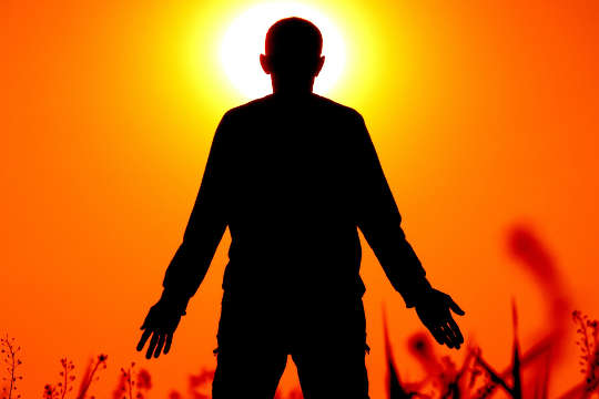 silhouette of a fan facing the sun 