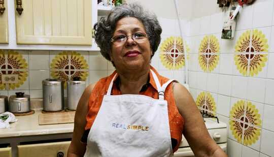 older person of color in 70s-style kitchen