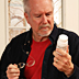 Man reading the label on a vitamin bottle.